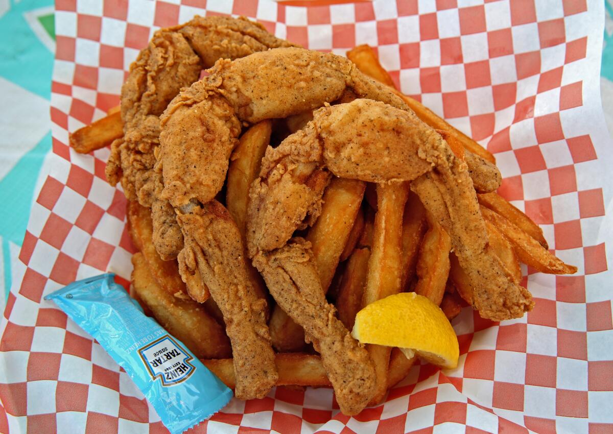 Fried frogs legs from Chicken Charlie's fill up a plate at the Orange County Fair.