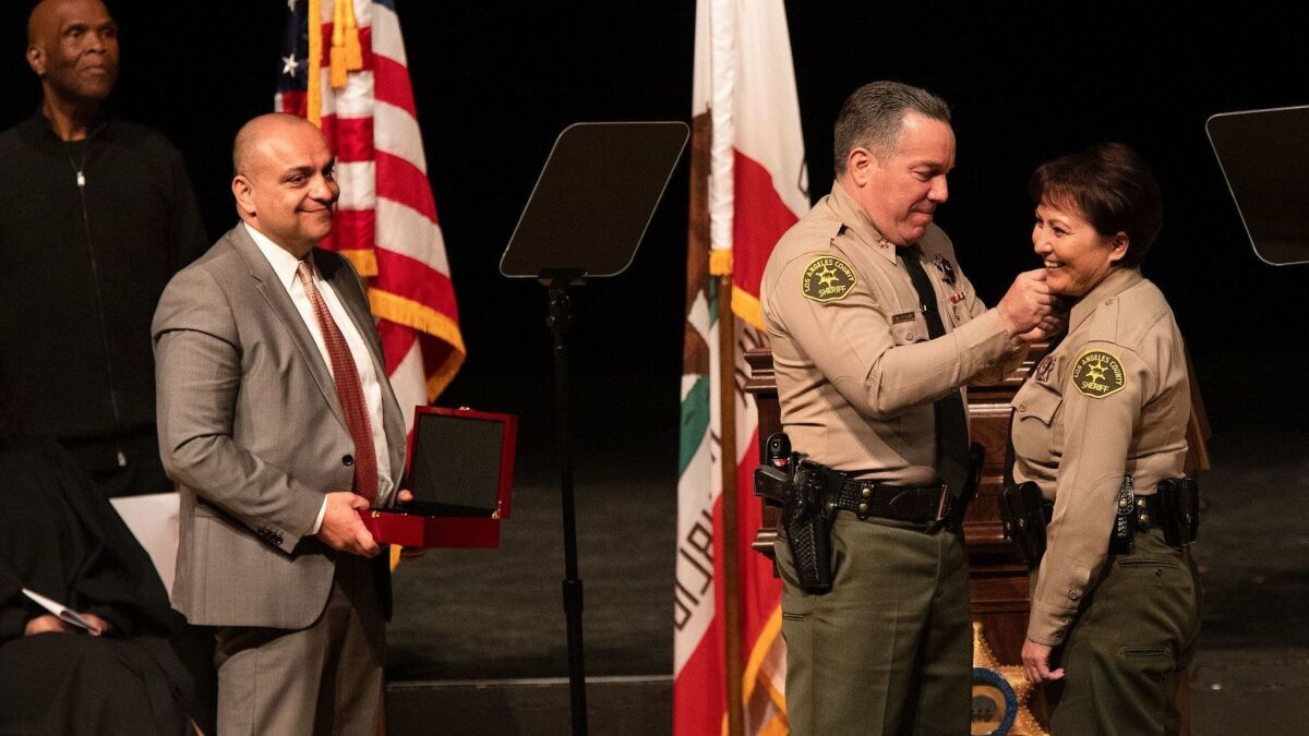 Caren Carl Mandoyan, left, with L.A. County Sheriff Alex Villanueva in December.