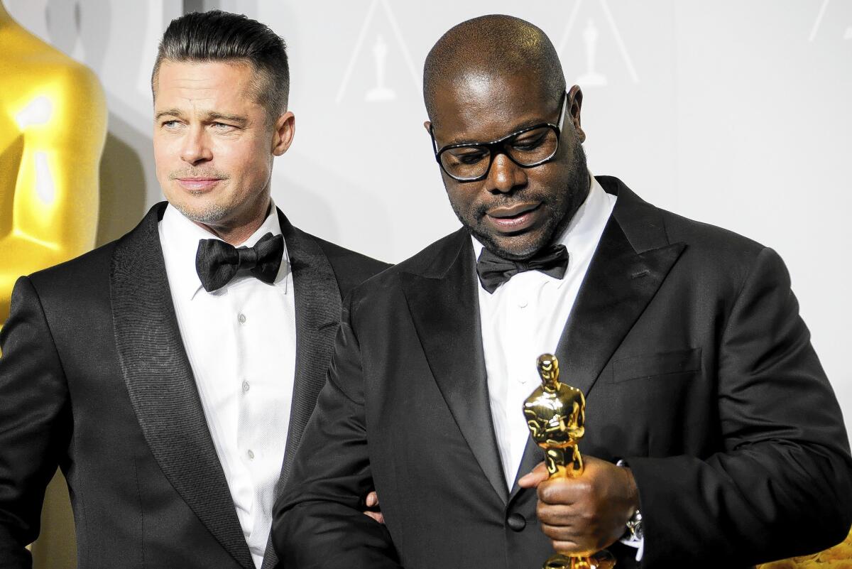 Brad Pitt, left, with "12 Years a Slave" director Steve McQueen after the film won the best picture Oscar.