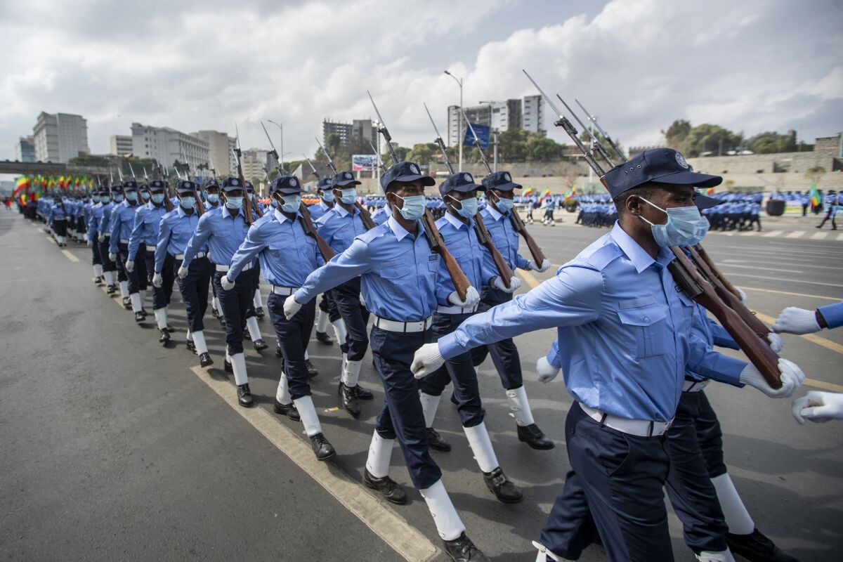 FILE - Ethiopian police march during a parade to display new police uniforms and instruct them to maintain impartiality and respect the law during the election, in Meskel Square in downtown Addis Ababa, Ethiopia on June 19, 2021. Ethiopia's government on Tuesday, Nov. 2, 2021 declared a national state of emergency as rival Tigray forces threaten to move on the capital as the country's yearlong war escalates quickly. (AP Photo/Ben Curtis, File)