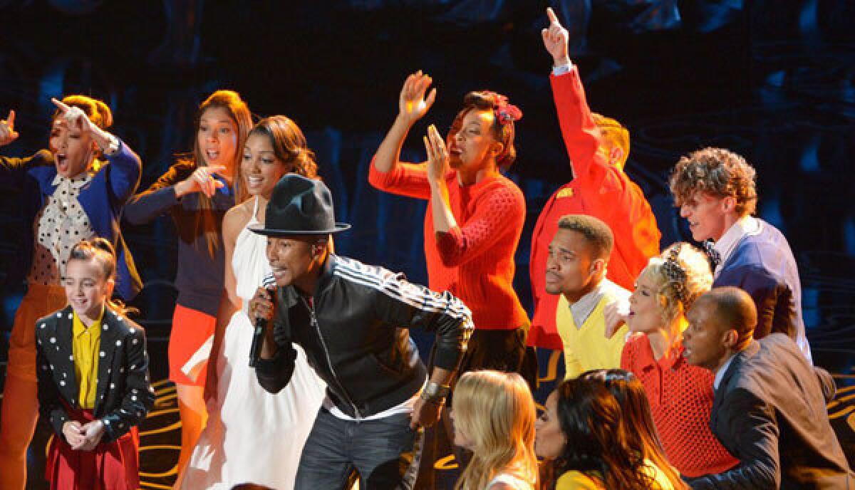 Pharrell Williams, performing along with his hat at the 2014 Oscars, has joined with the U.N. to promote the International Day of Happiness.