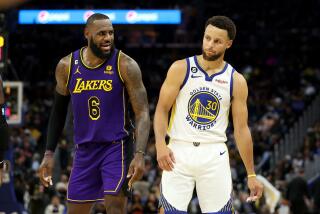 SAN FRANCISCO, CALIFORNIA - OCTOBER 18: LeBron James #6 of the Los Angeles Lakers speaks to Stephen Curry.