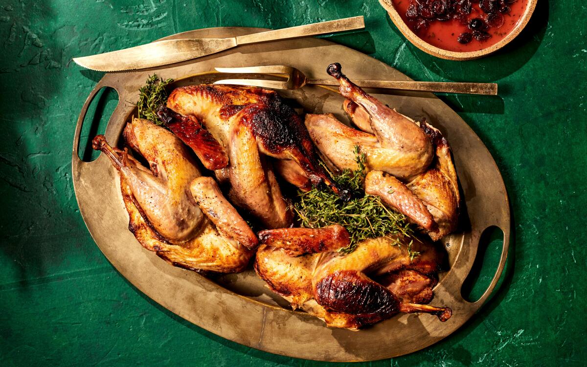 Golden pheasant roasted with bacon is served with a bright cranberry sauce.