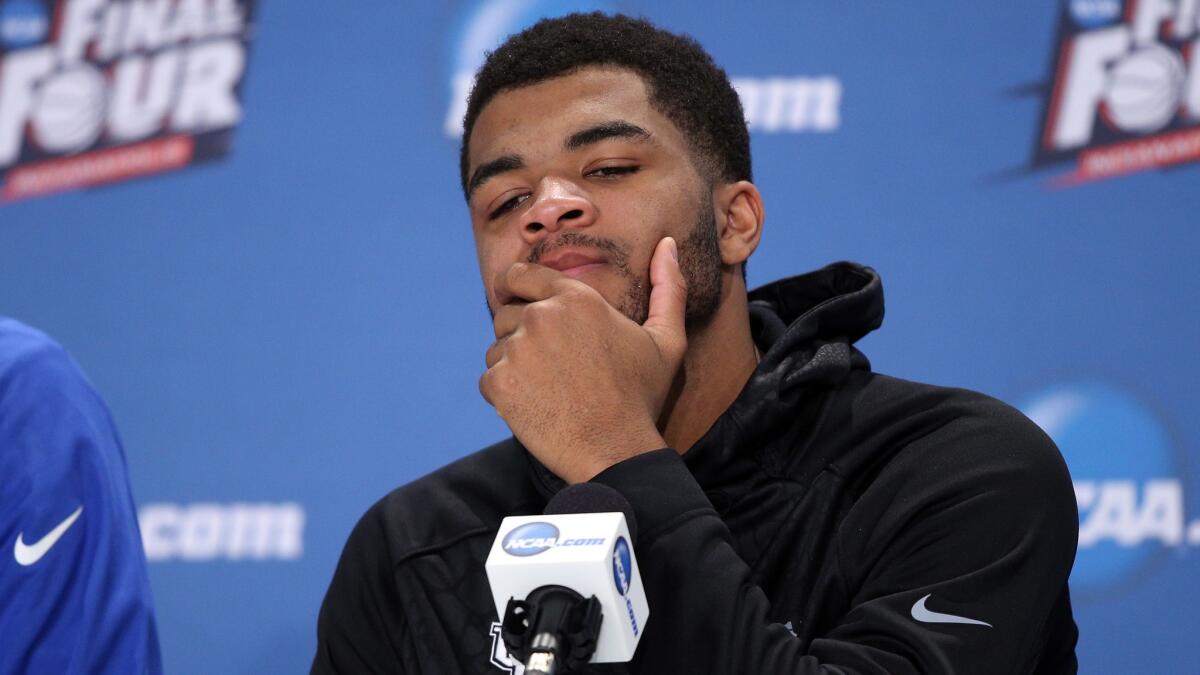 Kentucky's Andrew Harrison reacts during a postgame news conference following the Wildcats' 71-64 loss to Wisconsin in the NCAA tournament semifinals on Saturday.