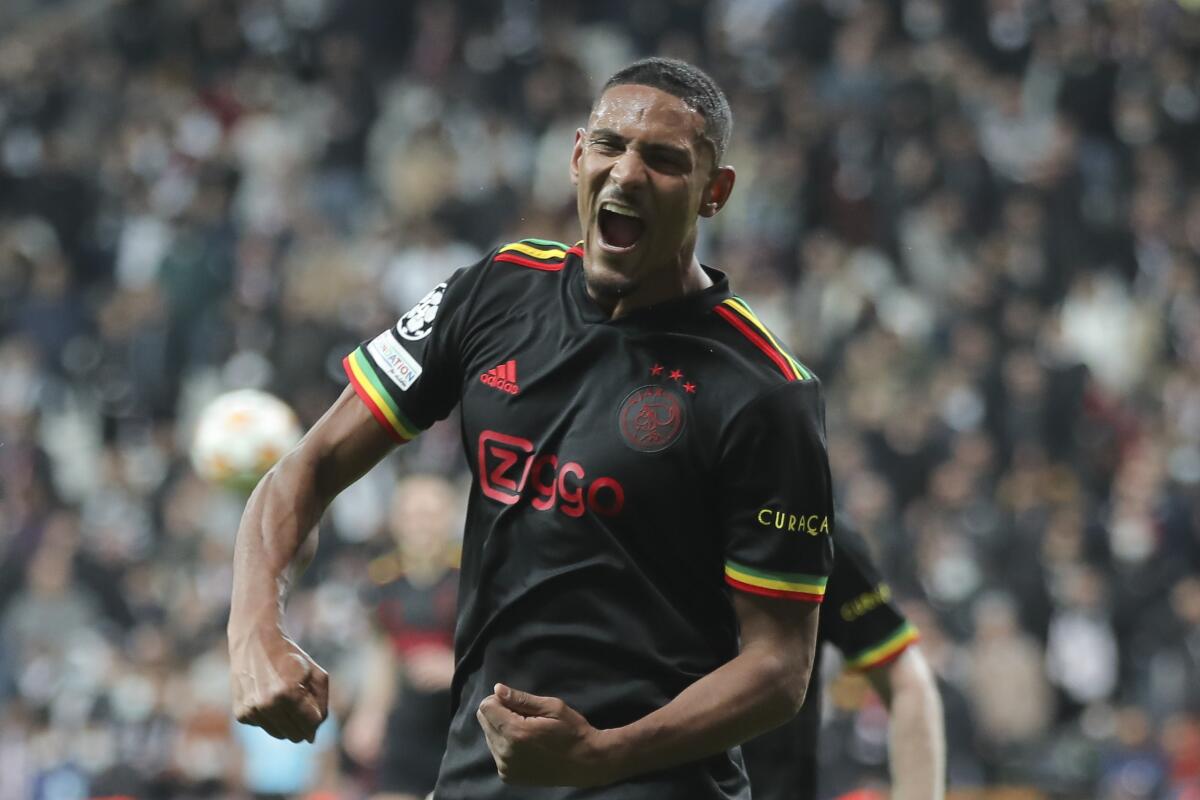 FILE - Ajax's Sebastien Haller celebrates scoring his side's second goal during the Champions League group C soccer match between Besiktas and Ajax at the Vodafone Park Stadium in Istanbul, Turkey, Wednesday, Nov. 24, 2021. Borussia Dortmund signed Ajax striker Sebastien Haller on a four-year contract Wednesday, July 6, 2022 to fill the gap left by the departing Erling Haaland. (AP Photo, File)