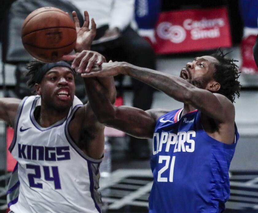 Sacramento Kings guard Buddy Hield blocks the shot of Clippers guard Patrick Beverley.