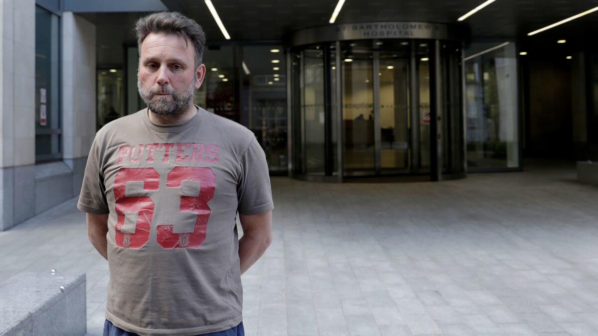 Patrick Ward, 47, a sales director from Dorset in England, stands outside St. Bartholomew's Hospital in London, on Friday, May 12, 2017, after his scheduled heart operation was canceled because of a cyberattack on the hospital.
