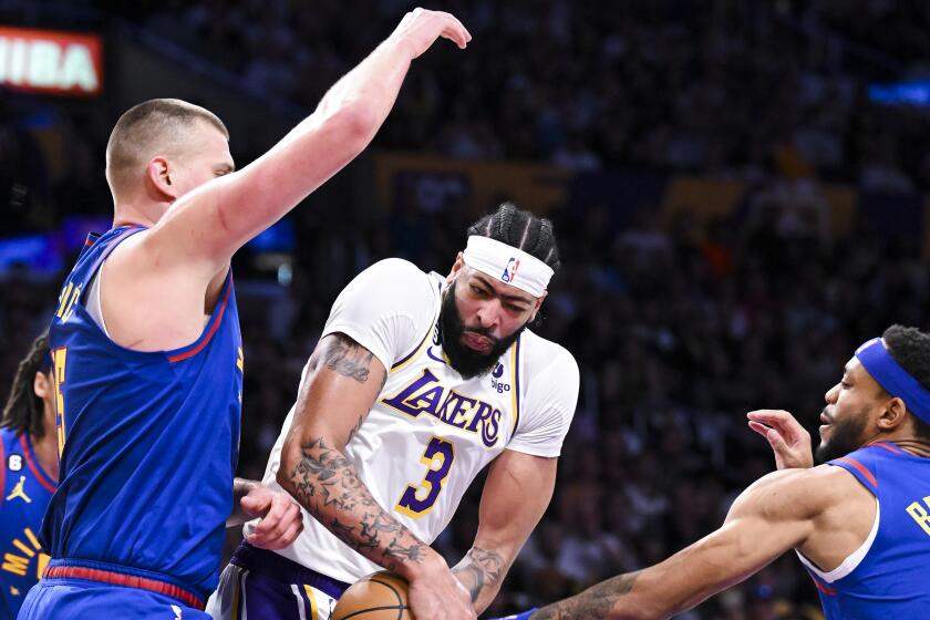 LOS ANGELES, CA - MAY 20: Denver Nuggets forward Bruce Brown, right, pokes the ball away from Los Angeles Lakers forward.