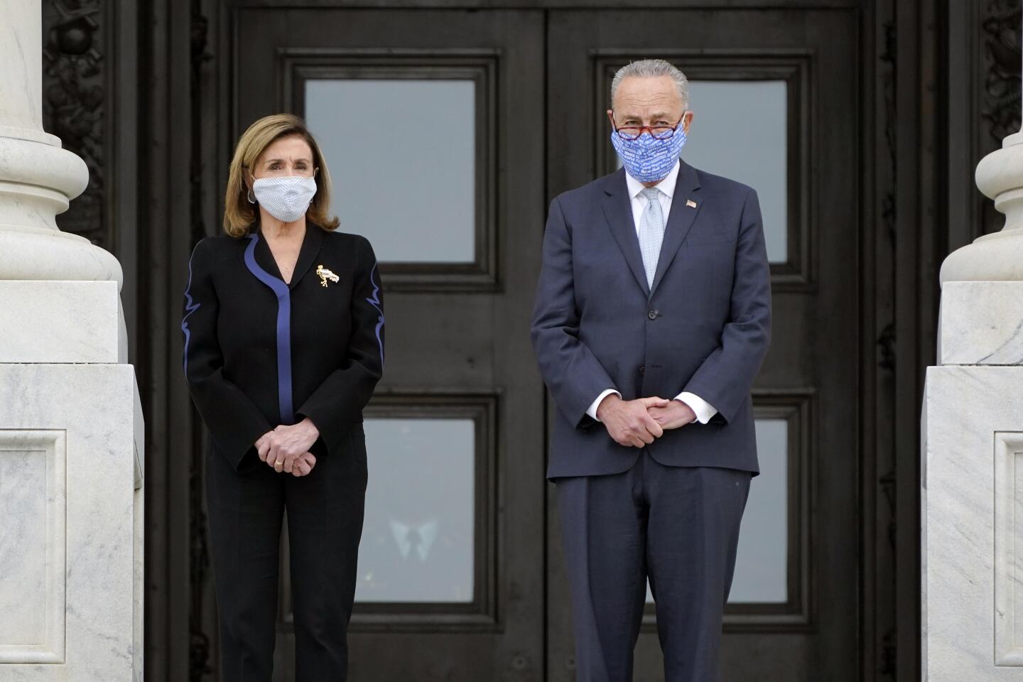 Speaker Nancy Pelosi and Sen. Charles E. Schumer await arrival of the casket of Justice Ruth Bader Ginsburg at the Capitol