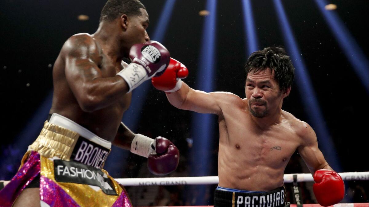 Manny Pacquiao, right, throws a right to Adrien Broner in the WBA welterweight title boxing match on Saturday in Las Vegas.