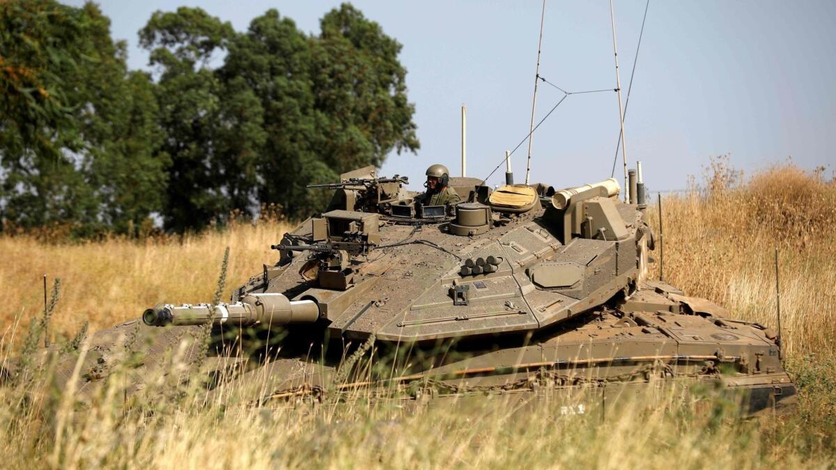 Israeli soldiers maneuver a Merkava tank in the Israeli-annexed Golan Heights on June 2.