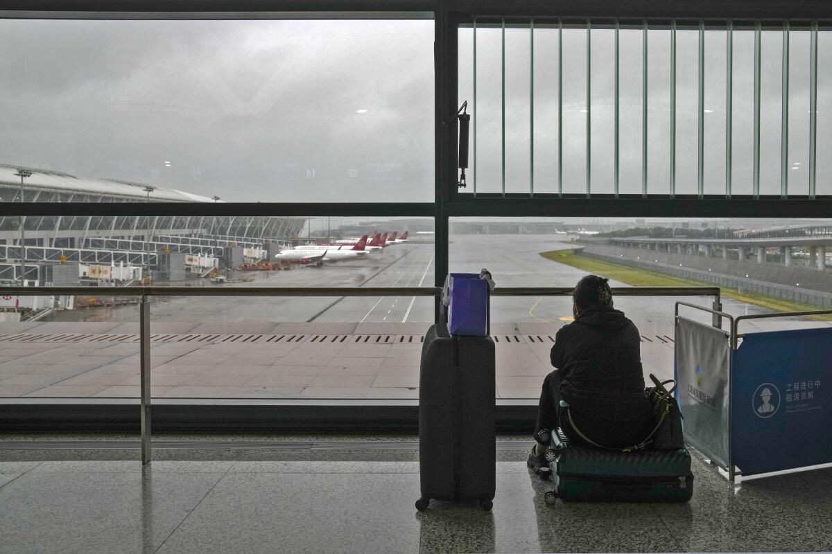 A passenger at Shanghai's Pudong International Airport after all flights were canceled Sunday.