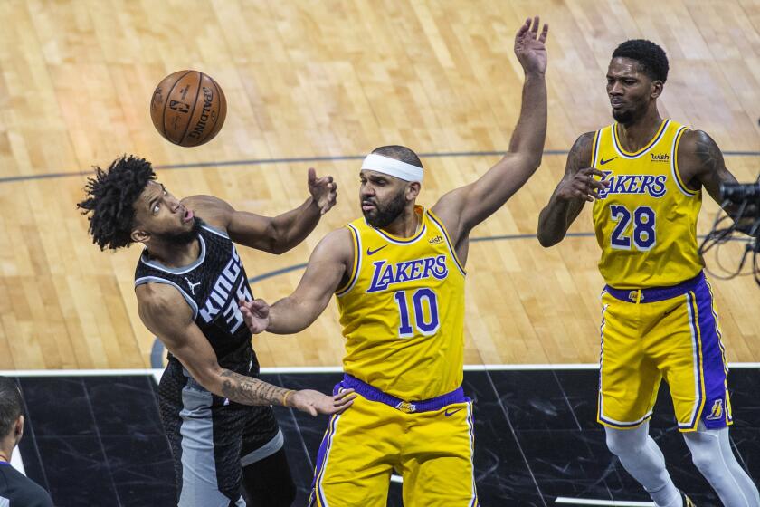 Sacramento Kings forward Marvin Bagley III (35) and Los Angeles Lakers forward Jared Dudley (10) try to get possession of the ball as Lakers forward Alfonzo McKinnie (28) watches during the fourth quarter of an NBA basketball game in Sacramento, Calif., Wednesday, March 3, 2021. (AP Photo/Hector Amezcua)