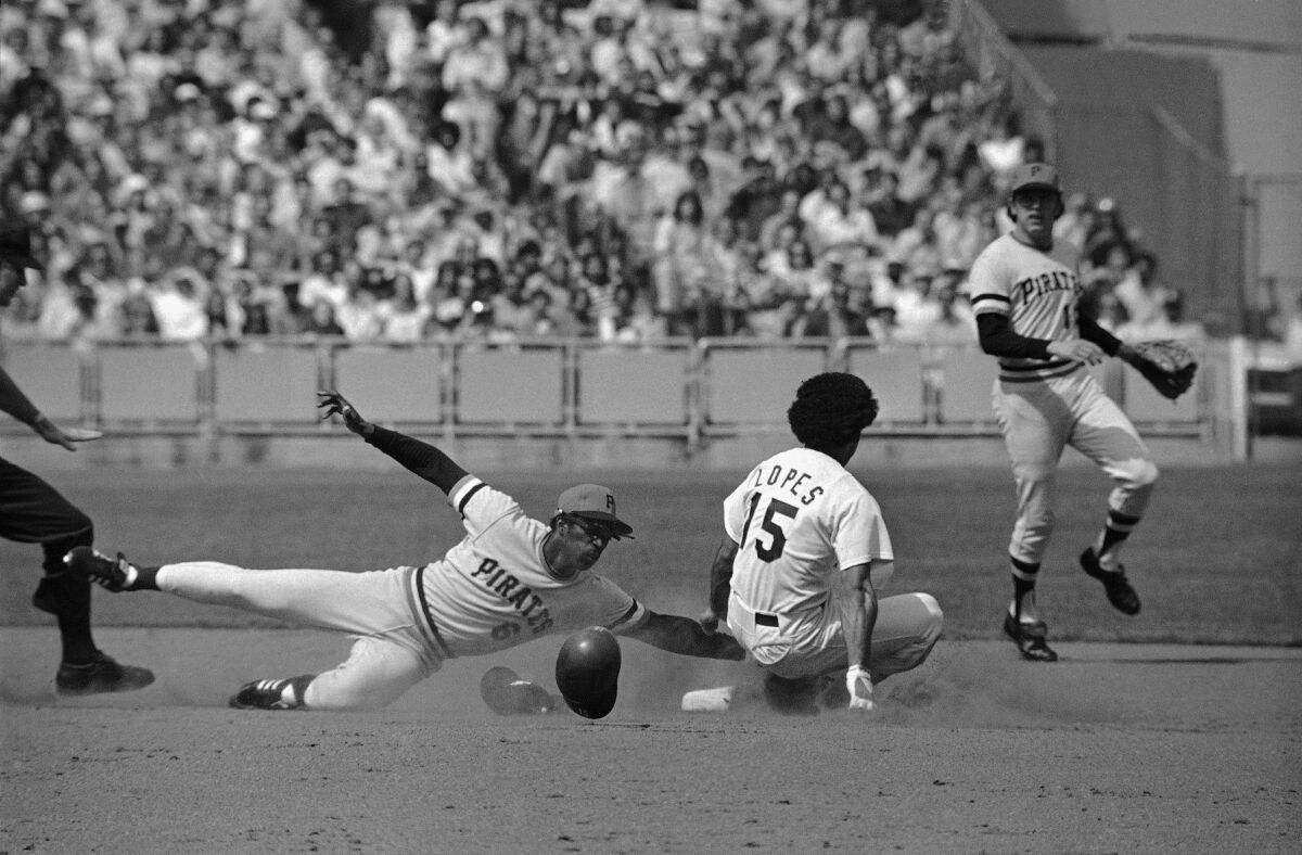 Second baseman Davey Lopes of the Dodgers slides safely into second base on a steal against the Pittsburgh Pirates.