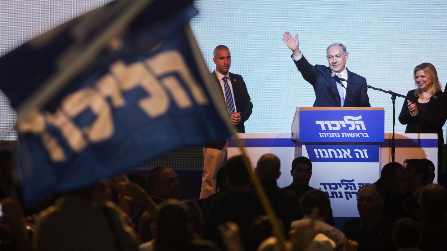 Israeli Prime Minister Benjamin Netanyahu greets supporters at the party's election headquarters In Tel Aviv on March 18, 2015.