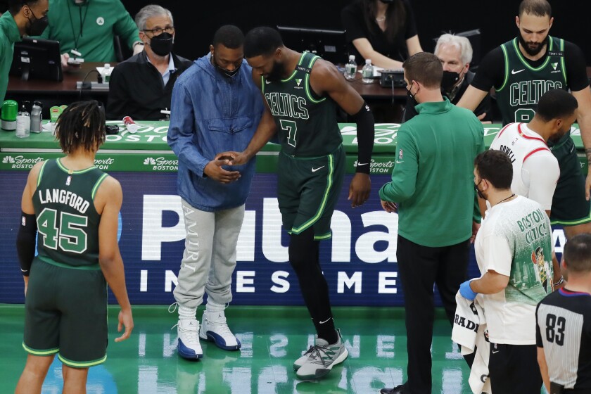 Boston Celtics' Kemba Walker, center left, helps Jaylen Brown (7) after Brown collided with teammate Jayson Tatum during the second half of an NBA basketball game against the Portland Trail Blazers, Sunday, May 2, 2021, in Boston. (AP Photo/Michael Dwyer)