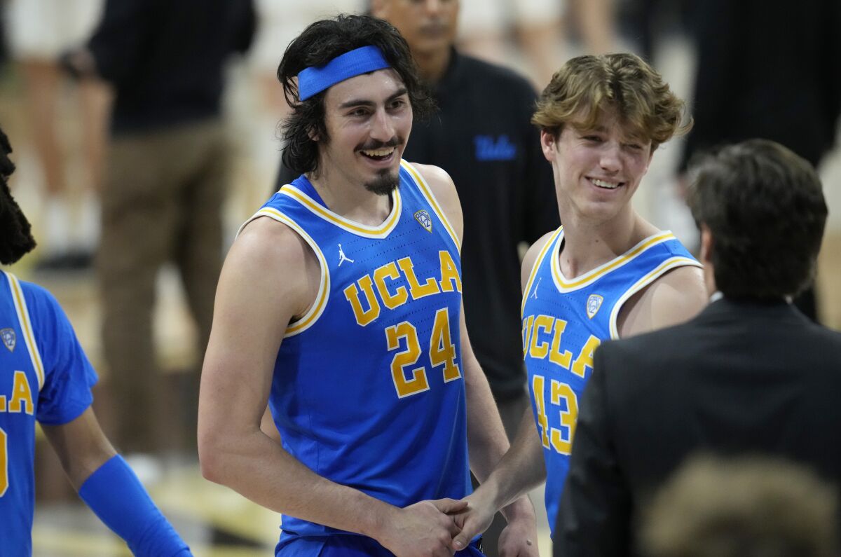 UCLA guard Jaime Jaquez Jr. celebrates with guard Russell Stong after a 60-56 victory over Colorado.