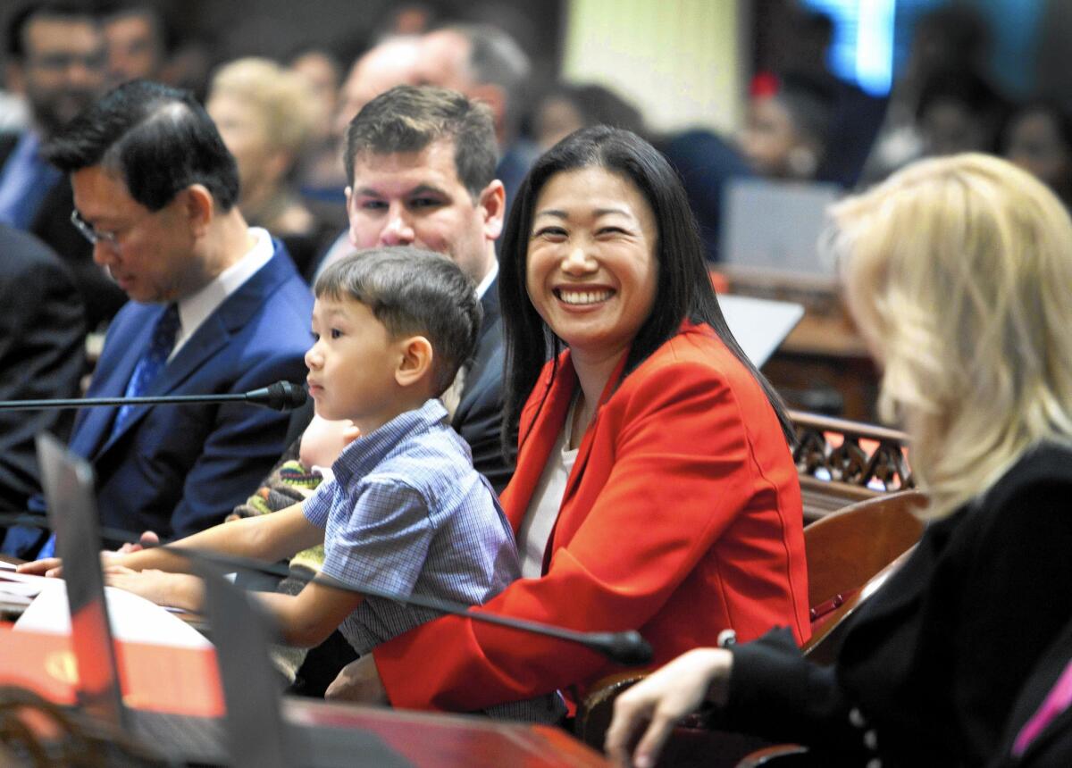 State Sen. Janet Nguyen (R-Santa Ana) holds her son Tommy Bonikowski III in state Senate chambers.