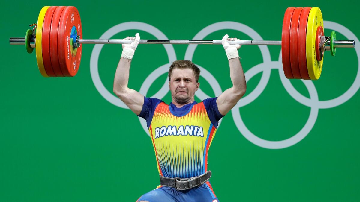 Romania's Gabriel Sincraian competes in the men's 85-kilogram weightlifting category at the 2016 Summer Olympics.