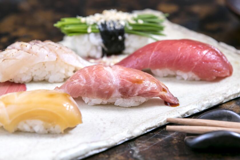 ENCINO, CALIFORNIA - Nov. 27, 2019: A sushi selection by Shin Sushi chef-owner Taketoshi Azumi's seasonal omasake menu - (clockwise from top left) seared ebodai (butterfish), menegi (Japanese chives) with bonito, wild Bluefin tuna from Boston, wild o-toro (fatty) Bluefin tuna, and soy-marinated kurodai (Black Snapper), photographed on Thursday Nov. 27, 2019, at his small sushi bar in a strip mall in Encino. (Photo / Silvia Razgova) Assignment ID: 473491