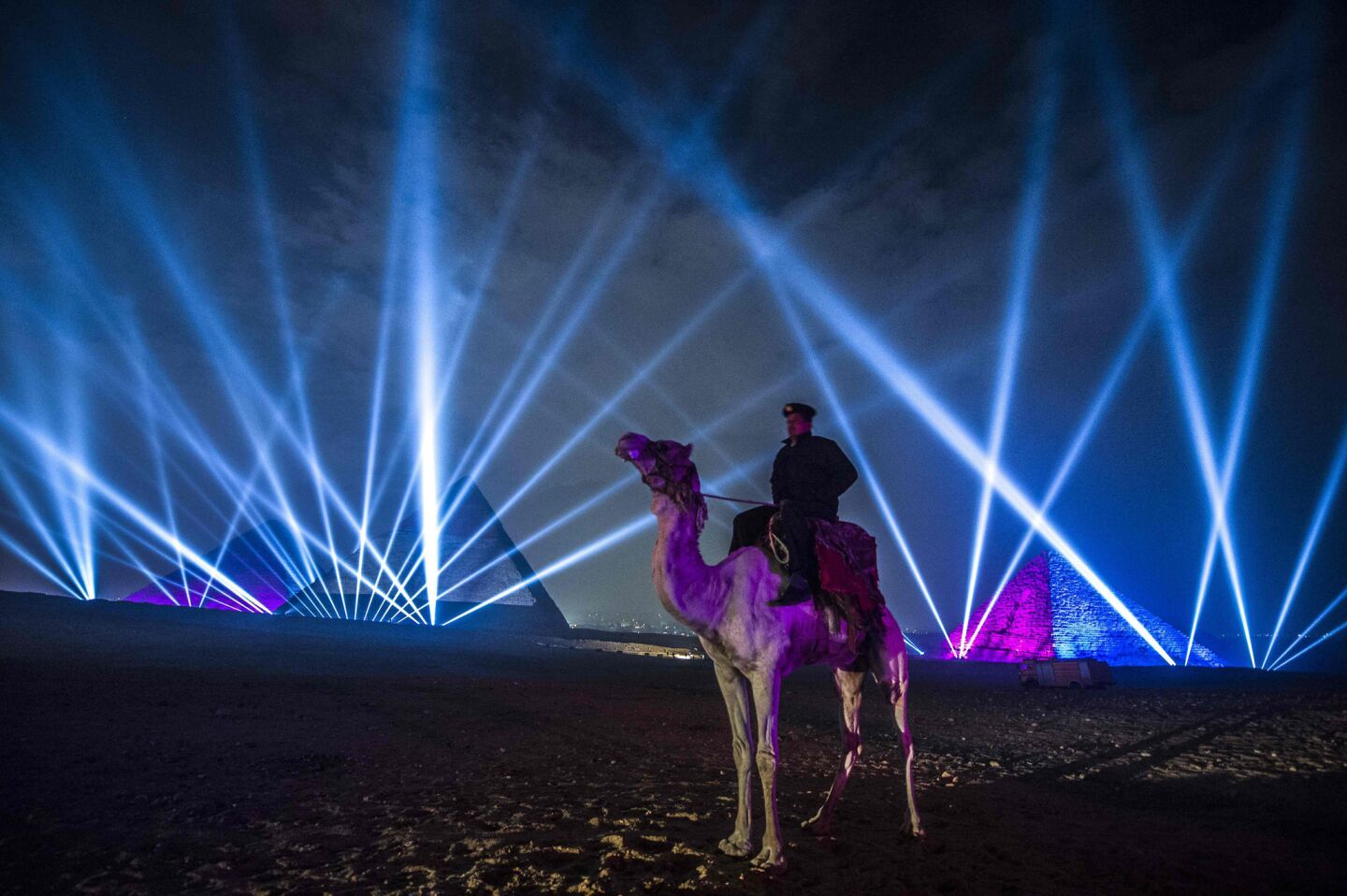 An Egyptian policeman stands guard during New Year celebrations in front of the pyramids near Cairo.