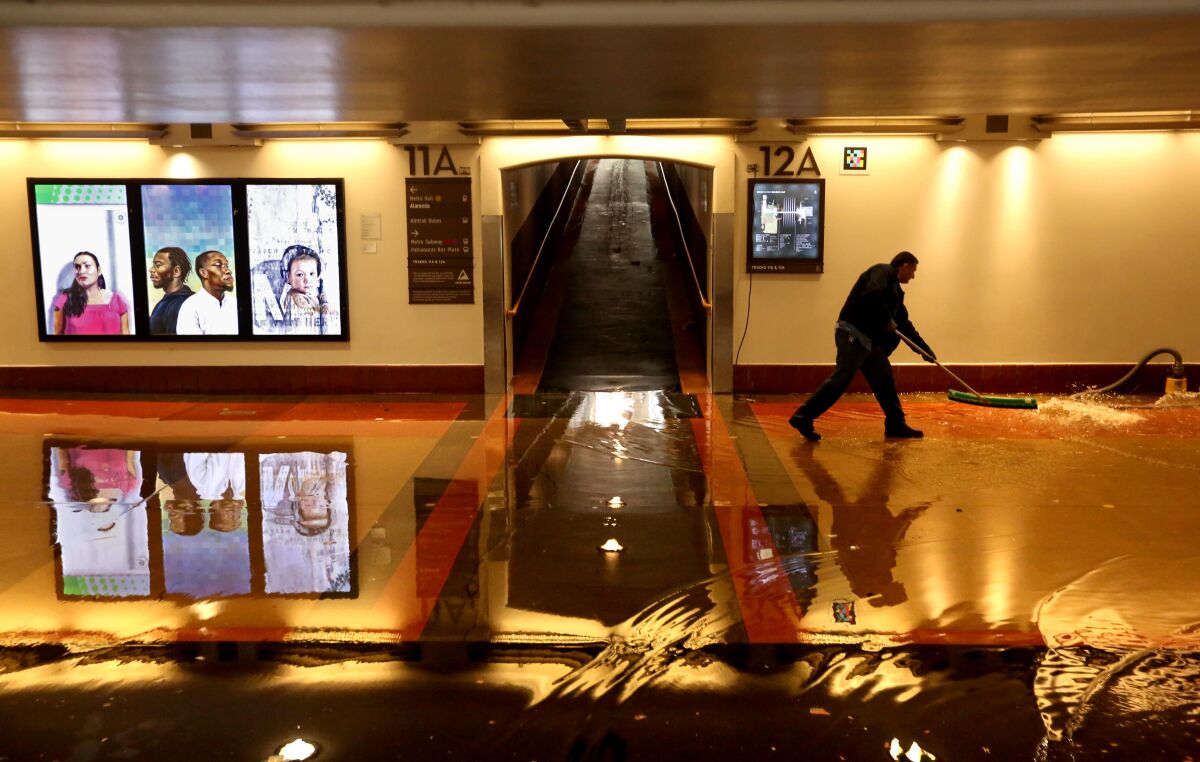A Metro worker cleans up water inside Union Station on in Los Angeles. 