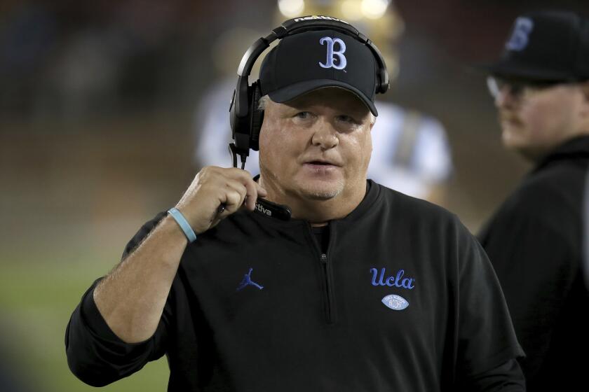 UCLA coach Chip Kelly stands on the sideline a game against Stanford