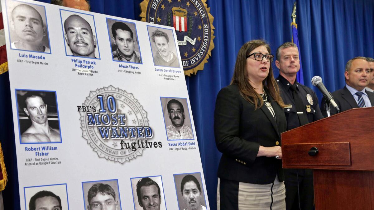 California law enforcement officials unveil suspects on the FBI's 10 most wanted fugitives list in May. (Nick Ut / Associated Press)