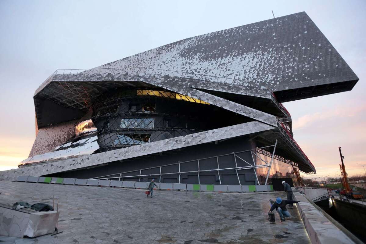 Workers at the new Philharmonie de Paris ahead of its opening in Paris on Jan. 13.