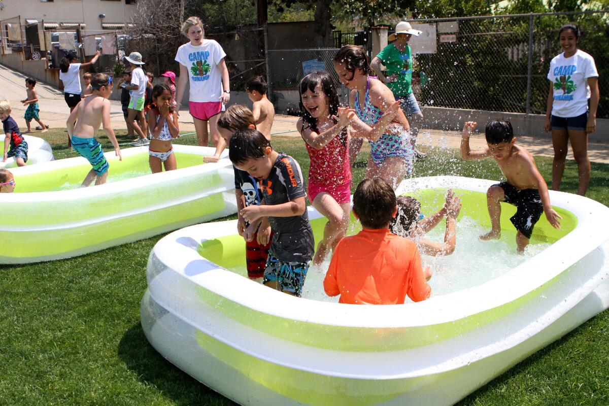 Camp Runamuk participants frolic in three small inflatible pools during water play at the Community Center of La Cañada Flintridge in La Cañada Flintridge on Tuesday, June 21, 2016.