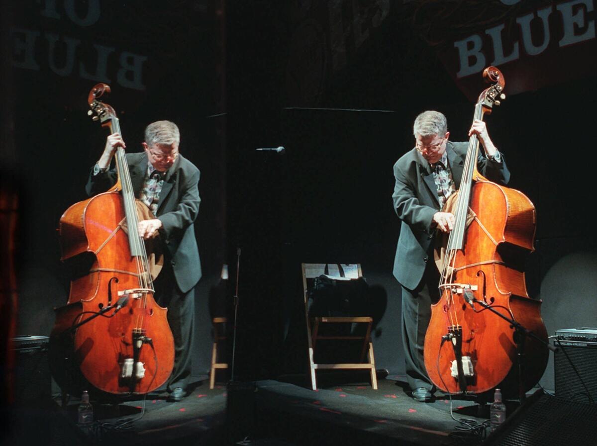 Jazz bassist Charlie Haden, right, and his plexiglas reflection during a sound check at the House of Blues in West Hollywood before a performance by his band Quartet West in 1997.