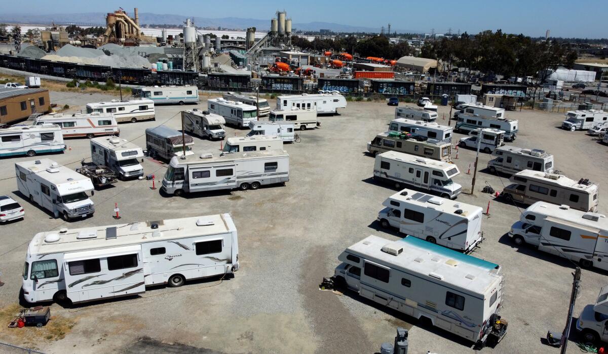 Many RVs and campers in a large parking lot