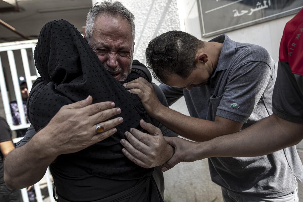 Relatives of Muhammad Hassouna, who was killed during an Israeli airstrike, weep before his funeral.