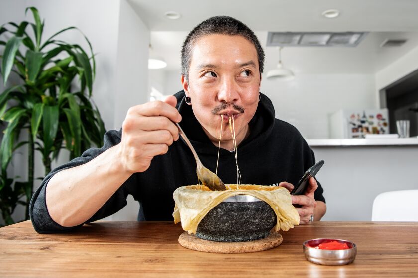 LOS ANGELES, CA - APRIL 20: Chef Chris Oh tastes his recent dish, "cheesy Japanese curry chicken pot pie", at his home on Monday, April 20, 2020 in Los Angeles, CA. During the Safer At Home order due to the Covid-19 pandemic, Oh has used the time to create and post numerous videos of his cooking. (Mariah Tauger / Los Angeles Times)