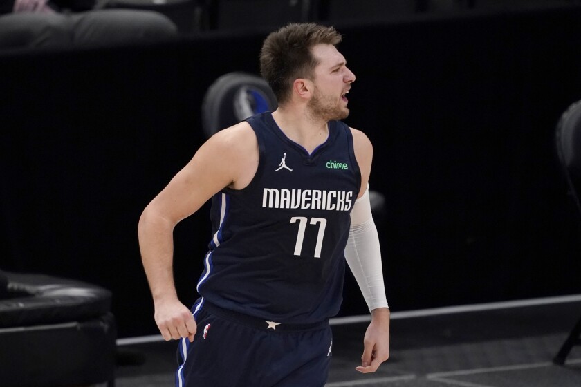 Dallas Mavericks' Luka Doncic celebrates after sinking a three-point basket in the second half of an NBA basketball game against the Golden State Warriors in Dallas, Saturday, Feb. 6, 2021. (AP Photo/Tony Gutierrez)