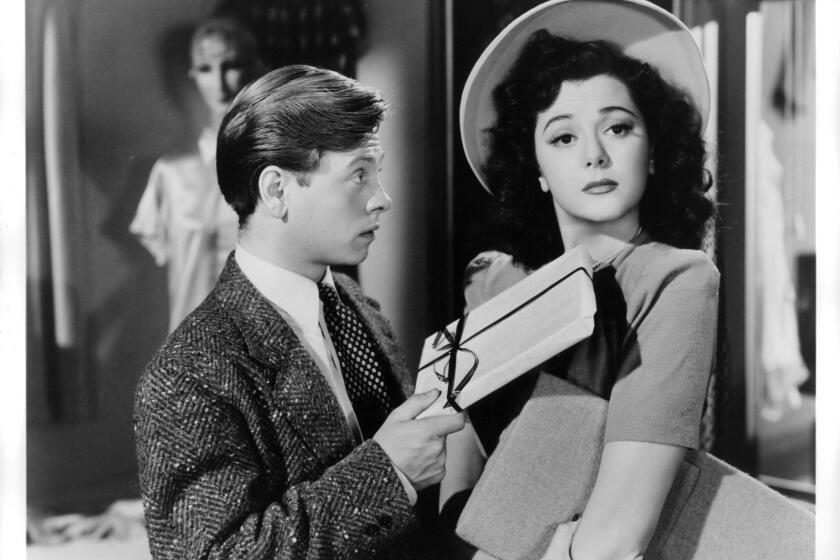 Mickey Rooney hands a gift to Ann Rutherford in a scene from the film "Andy Hardy's Private Secretary."