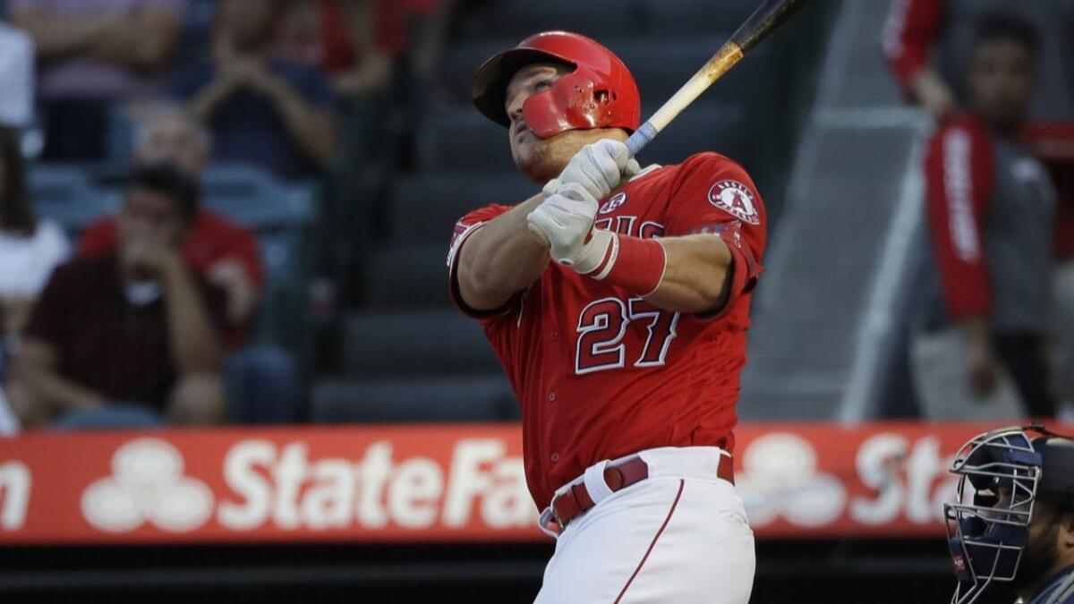 Mike Trout follows through on a two-run home run against the Seattle Mariners on Saturday.