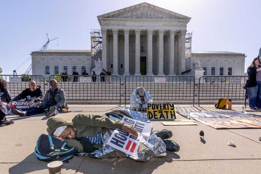 Activists demonstrate at the Supreme Court as the justices consider a challenge to rulings that found punishing people for sleeping outside when shelter space is lacking amounts to unconstitutional cruel and unusual punishment, on Capitol Hill in Washington, Monday, April 22, 2024. (AP Photo/J. Scott Applewhite)