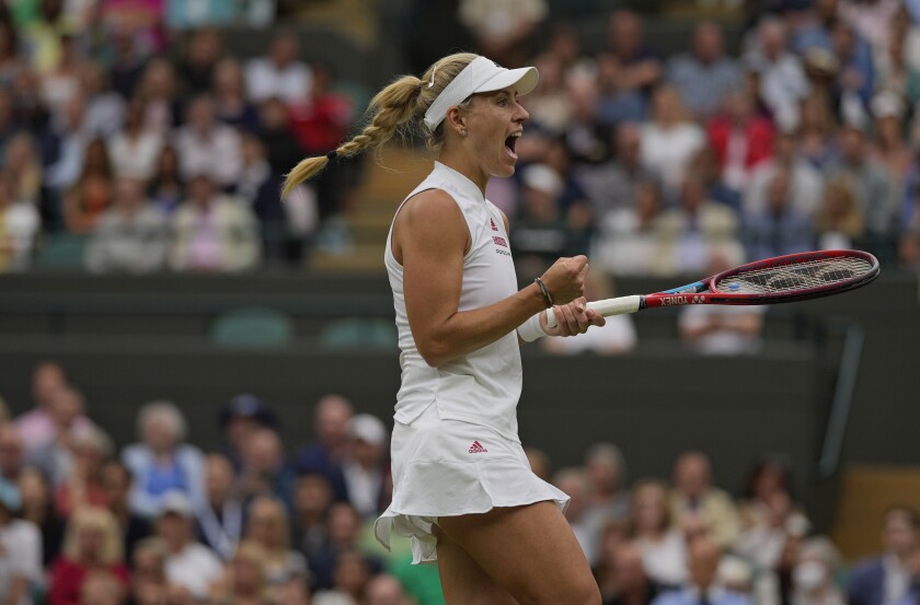 Germany's Angelique Kerber celebrates winning a game against Czech Republic's Karolina Muchova during the women's singles quarterfinals match on day eight of the Wimbledon Tennis Championships in London, Tuesday, July 6, 2021.(AP Photo/Alastair Grant)