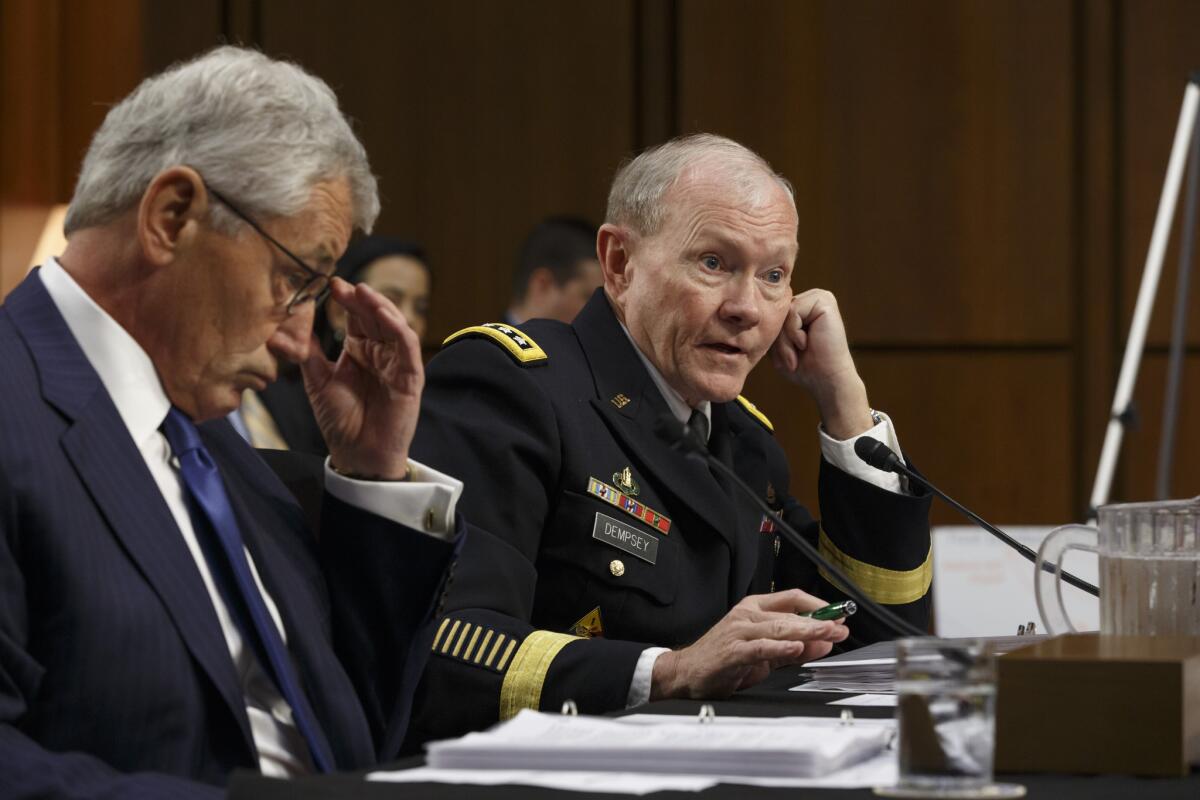 Army Gen. Martin Dempsey, right, chairman of the Joint Chiefs of Staff, appears before the Senate Armed Services Committee with Defense Secretary Chuck Hagel on Tuesday. Dempsey later headed across the Atlantic to consult with French officials about Iraq.
