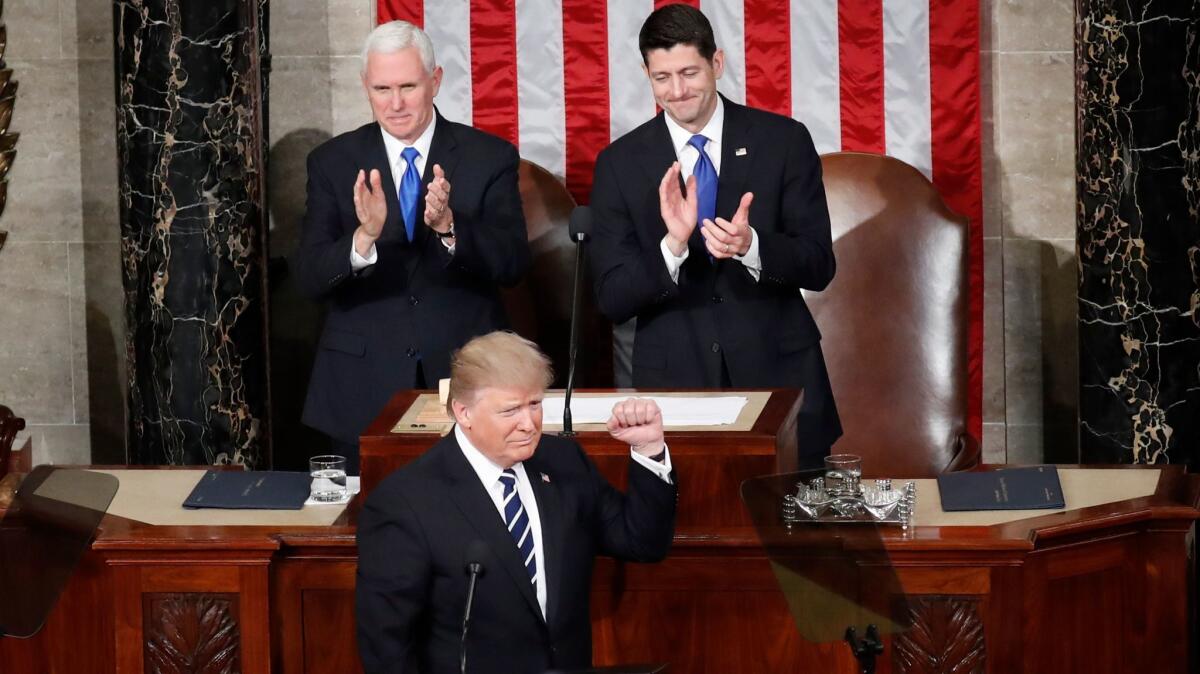 President Donald Trump, flanked by Vice President Mike Pence and House Speaker Paul Ryan of Wis., gestures on Capitol Hill, before his address to a joint session of Congress on Feb. 28, 2017.
