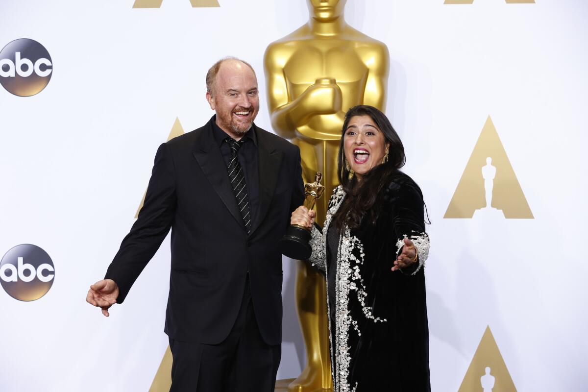 Sharmeen Obaid-Chinoy with her Oscar for "A Girl in the River: The Price of Forgiveness," and presenter Louis C.K. backstage at the 88th Academy Awards.