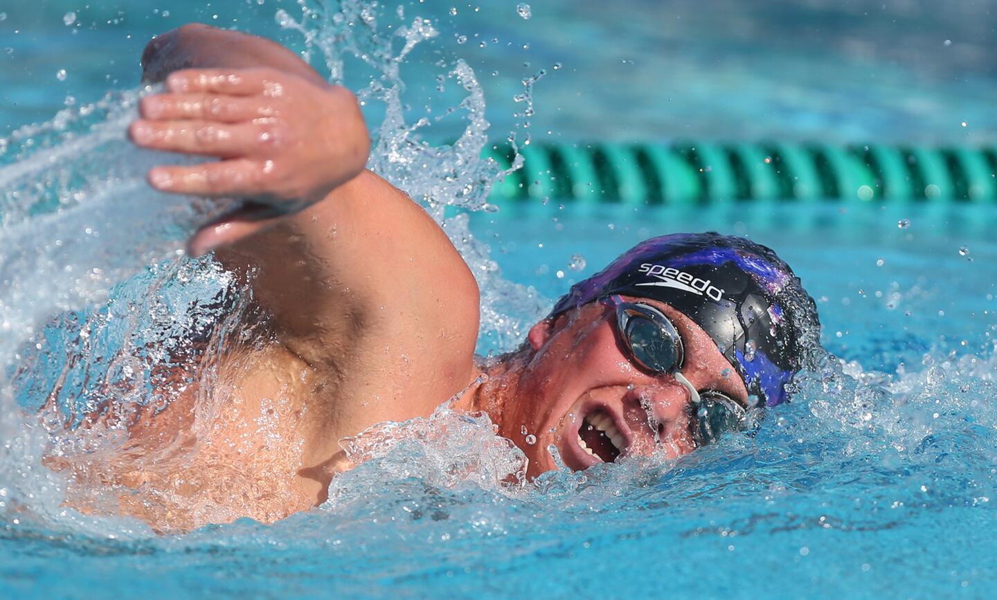 Augie Cunningham swims toward winning the 200 free during swim meet with Estancia High Wednesday at Costa Mesa High.