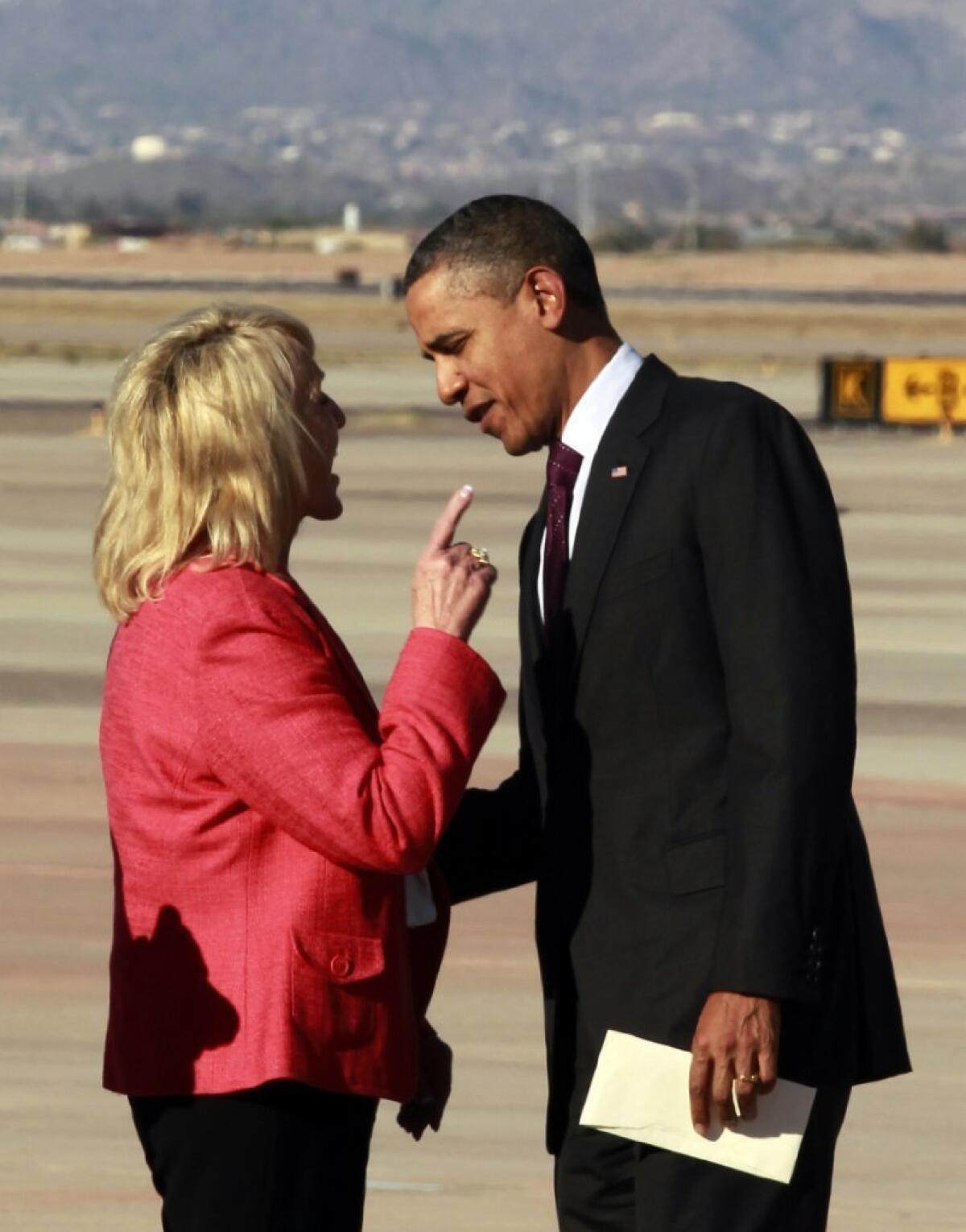 Arizona Gov. Jan Brewer has an intense conversation with President Obama in January 2012 after his plane landed in Mesa, Ariz. Their meeting this time, on the tarmac at Phoenix Sky Harbor International Airport, was friendlier.