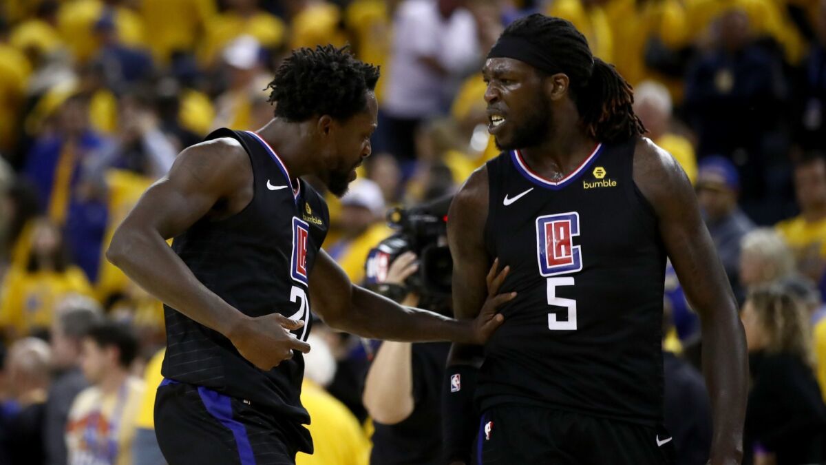 Patrick Beverley, left, and Montrezl Harrell of the Clippers celebrate after they beat the Golden State Warriors during Game 2 of the first round of the NBA Western Conference Playoffs.