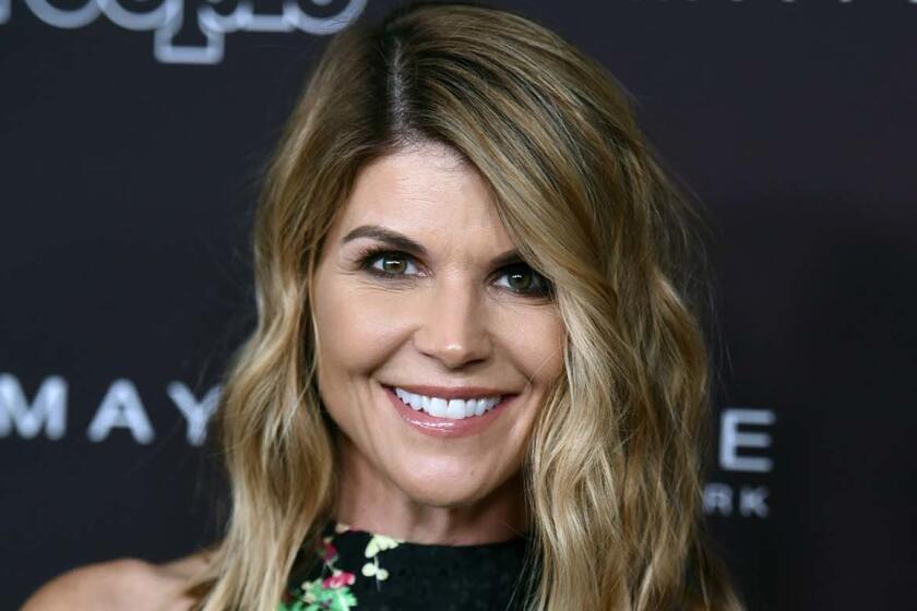 FILE - In this Oct. 4, 2017 file photo, actress Lori Loughlin arrives at the 5th annual People Magazine "Ones To Watch" party in Los Angeles. The FBI says Loughlin has been taken into custody in connection with a scheme in which wealthy parents paid bribes to get their children into top colleges. FBI spokeswoman Laura Eimiller says Loughlin was in custody Wednesday morning in Los Angeles. She is scheduled to appear in court there in the afternoon. (Photo by Richard Shotwell/Invision/AP, File)