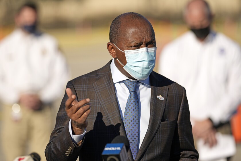 Houston Mayor Sylvester Turner speaks while masked at an outdoor vaccination site 