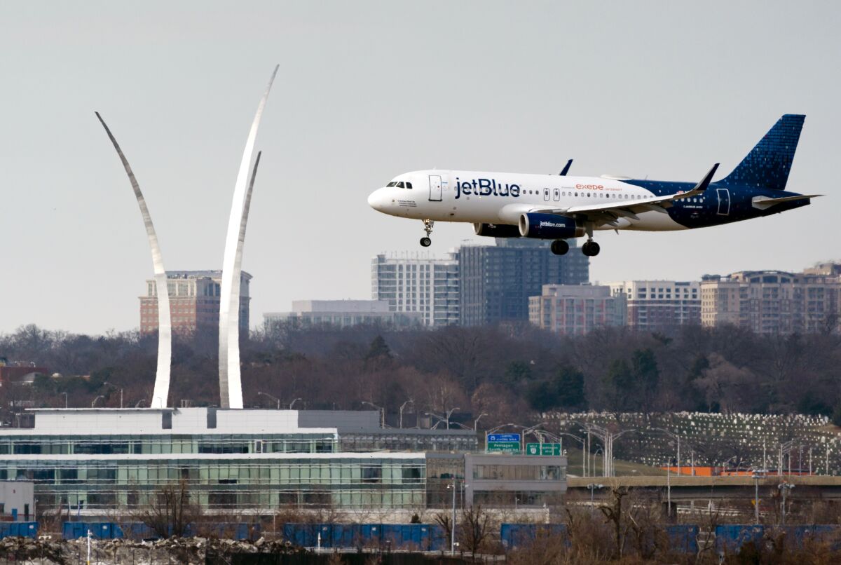 FILE - A JetBlue passenger flight lands at Reagan Washington National Airport in Arlington, Va., across the Potomac River from Washington, Wed., Jan. 19, 2022. On Friday, June 17, 2022, federal regulators said Verizon and AT&T will delay part of their 5G rollout near airports to give airlines more time to ensure that equipment on their planes is safe from interference from the wireless signals, but the airline industry is not happy about the deal. (AP Photo/J. Scott Applewhite, File)