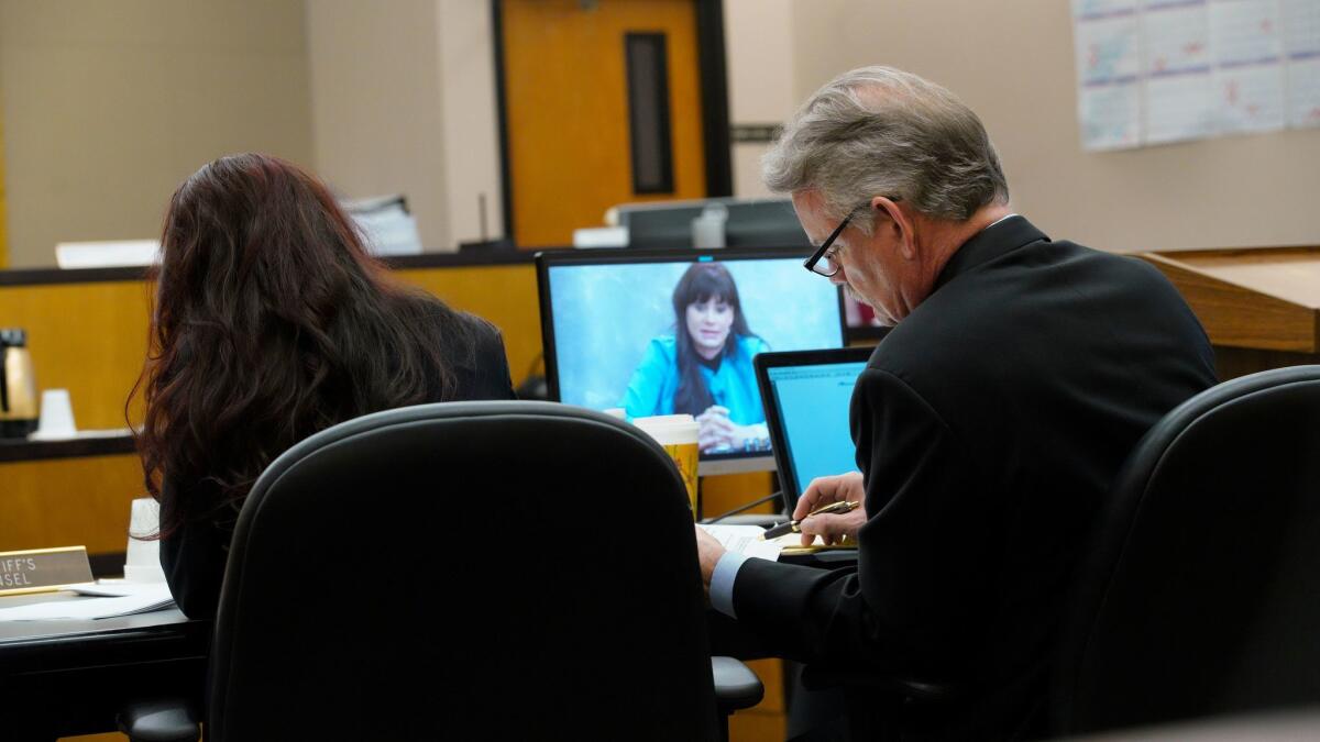 C. Keith Greer, attorney for plaintiff Mary Zahau-Loehner (left), reviews over his notes as the video playback of Dina Shacknai's deposition taken on January 11, 2018 is played in court for the jury.