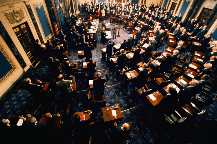 In the chamber of the United States Senate, Supreme Court Chief Justice William Rehnquist swears in the Senate members to participate in the impeachment trial of President William Jefferson Clinton. (Photo by © Wally McNamee/CORBIS/Corbis via Getty Images)